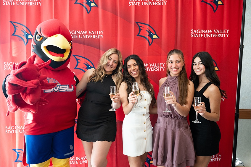 students posing with Coop at sr toast